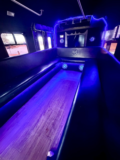 Bus-ta Move KC interior — bench seating and LED lighting